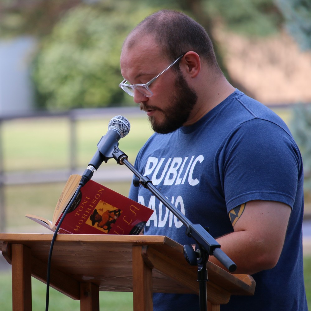 Student speaking at lectern for Avila University public reading