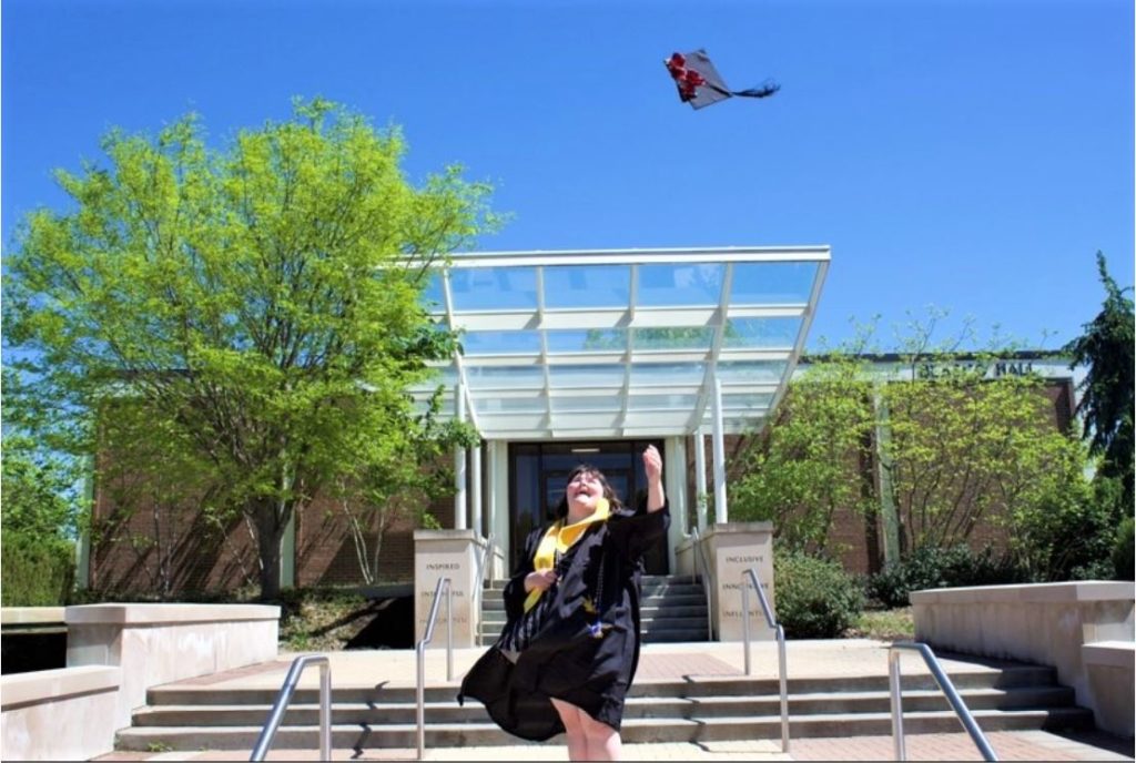 Graduate throws cap into the air