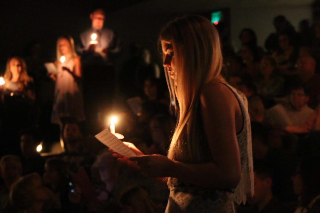 Nursing students read in unison during the candlelight portion of their pinning ceremony