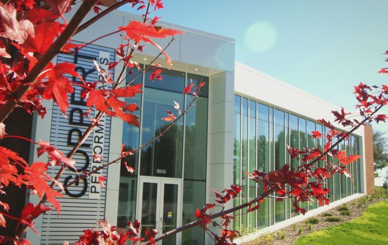The exterior of the Goppert Performing Arts Center in the fall