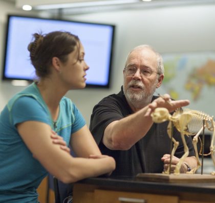 Avila Professor Robert Powell talking with a student