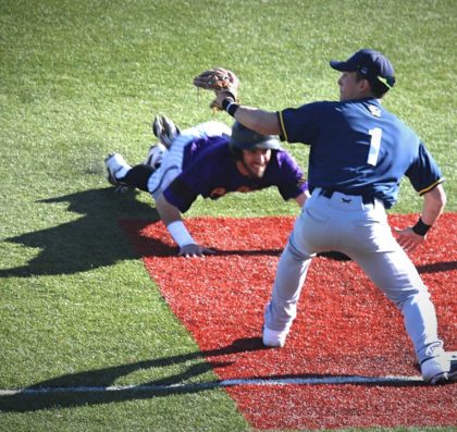 Avila players sliding head-first into third base to beat the tag