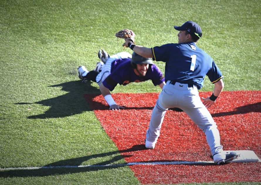 Avila players sliding head-first into third base to beat the tag