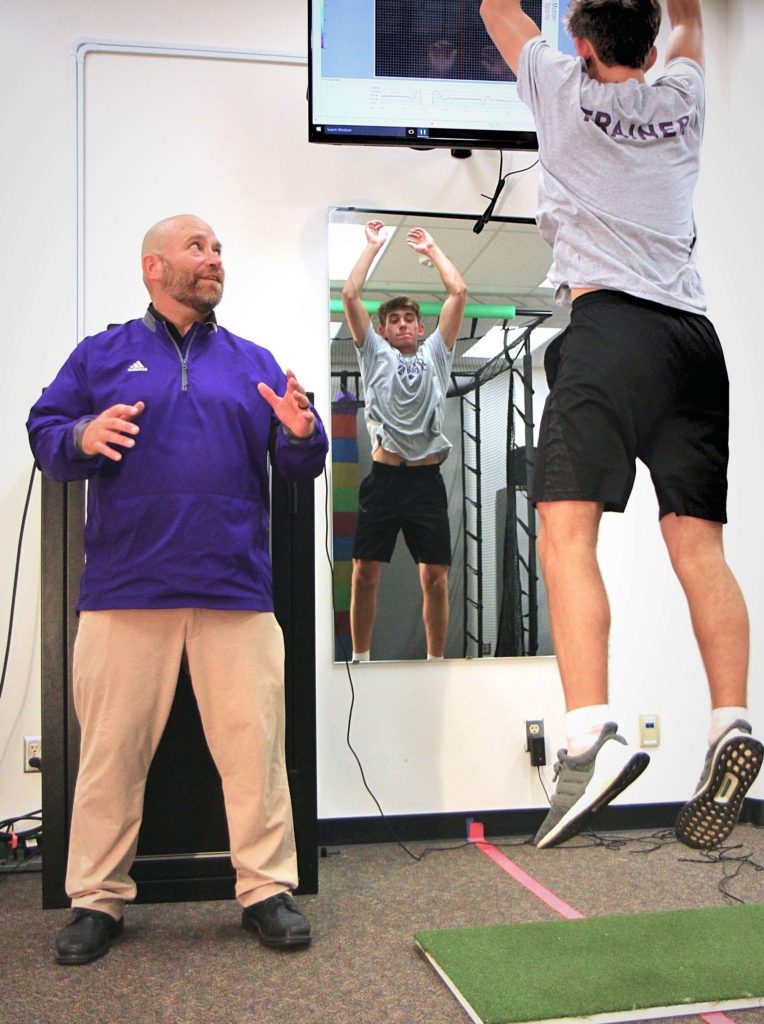 Professor Gerald Larson instructing Kinesiology student who is jumping in the lab