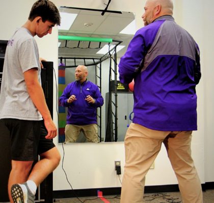 Professor Gerald Larson instructing a Kinesiology student in the lab