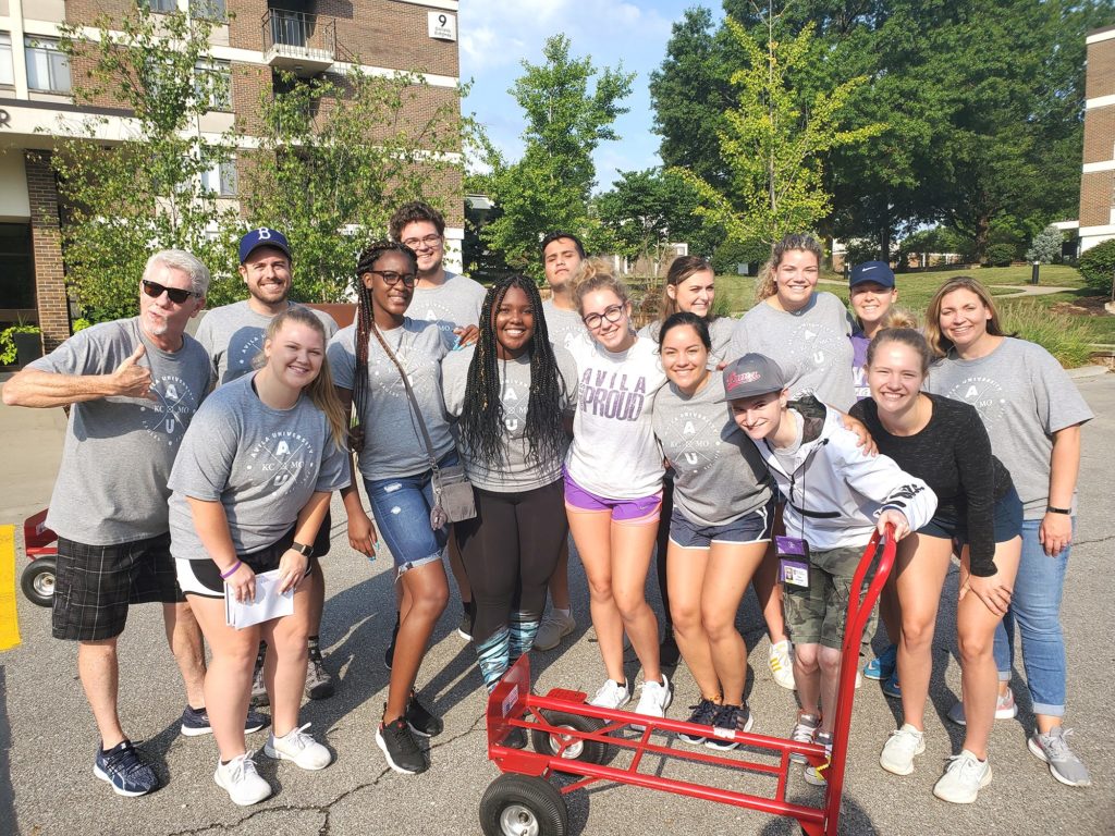 Group of 15 students and administrators posing during Move In day