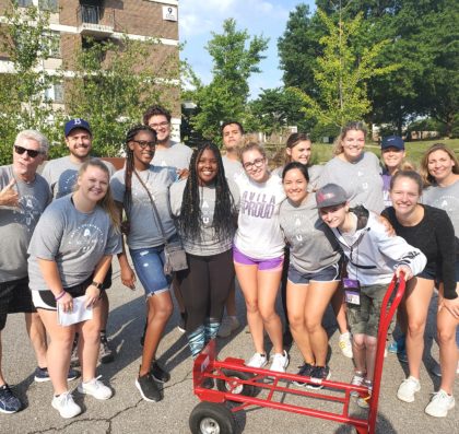 Group of 15 students and administrators posing during Move In day