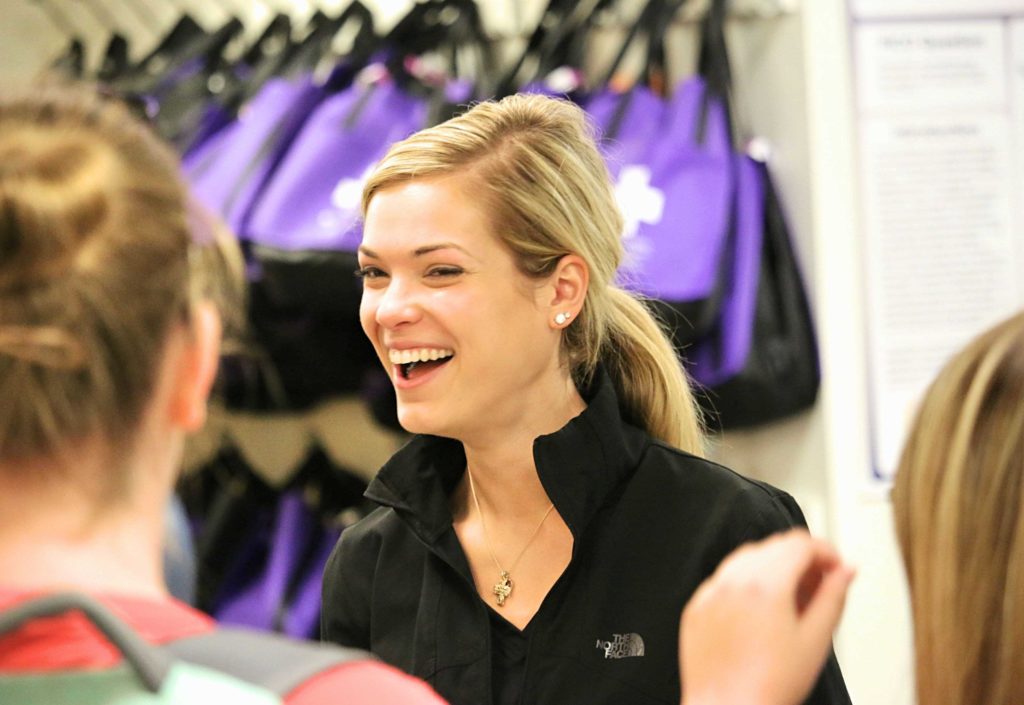 Avila nursing student laughing with two other students in the classroom