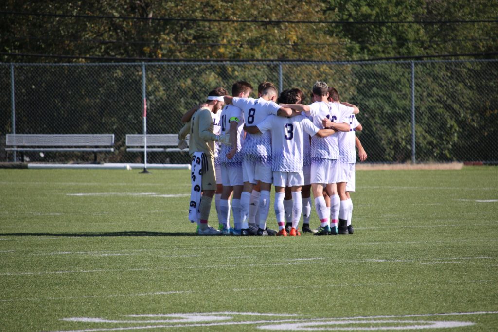 Avila men's soccer team huddled on the pitch of the Zarda Multiplex.