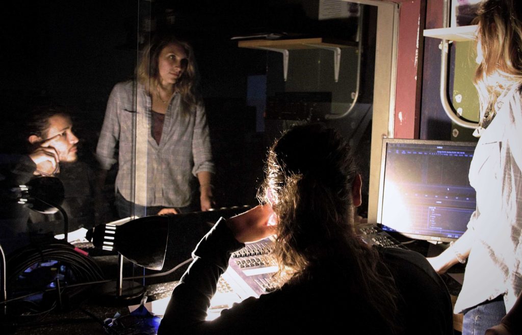 Two theatre students in the sound booth area of the Goppert Theatre