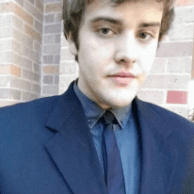 Headshot of young man in suit