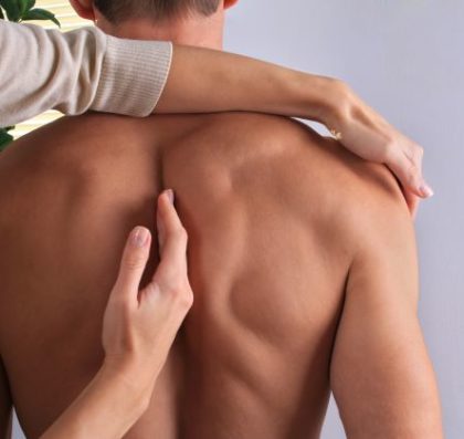 chiropractor adjusting a man's back