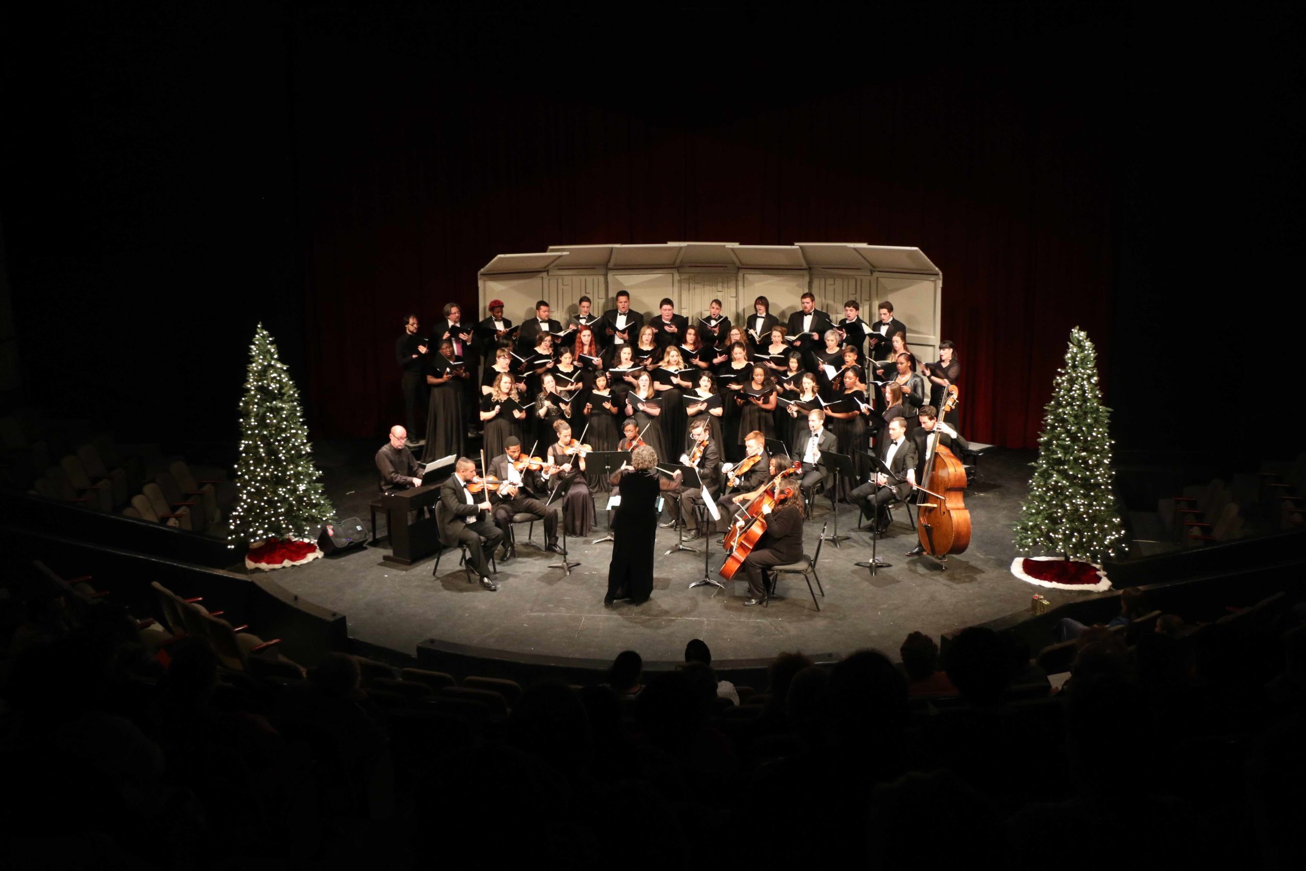 Avila choir and string performers on on the Goppert Theatre stage during a Christmas concert
