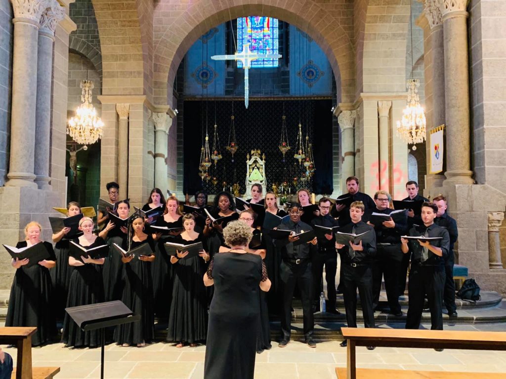 The Avila University Singers perform inside a church in France