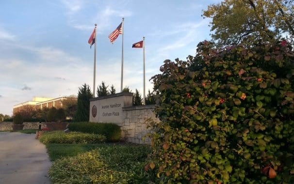 The flagpoles rising above the Jeanne Hamilton Olofson Plaza, commonly called the JHOP