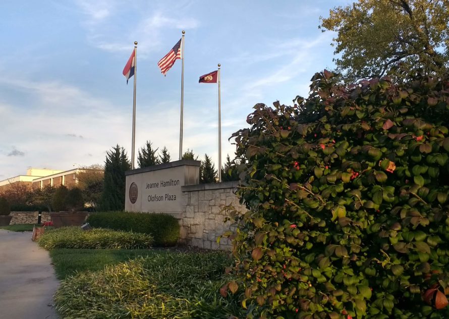 The flagpoles rising above the Jeanne Hamilton Olofson Plaza, commonly called the JHOP