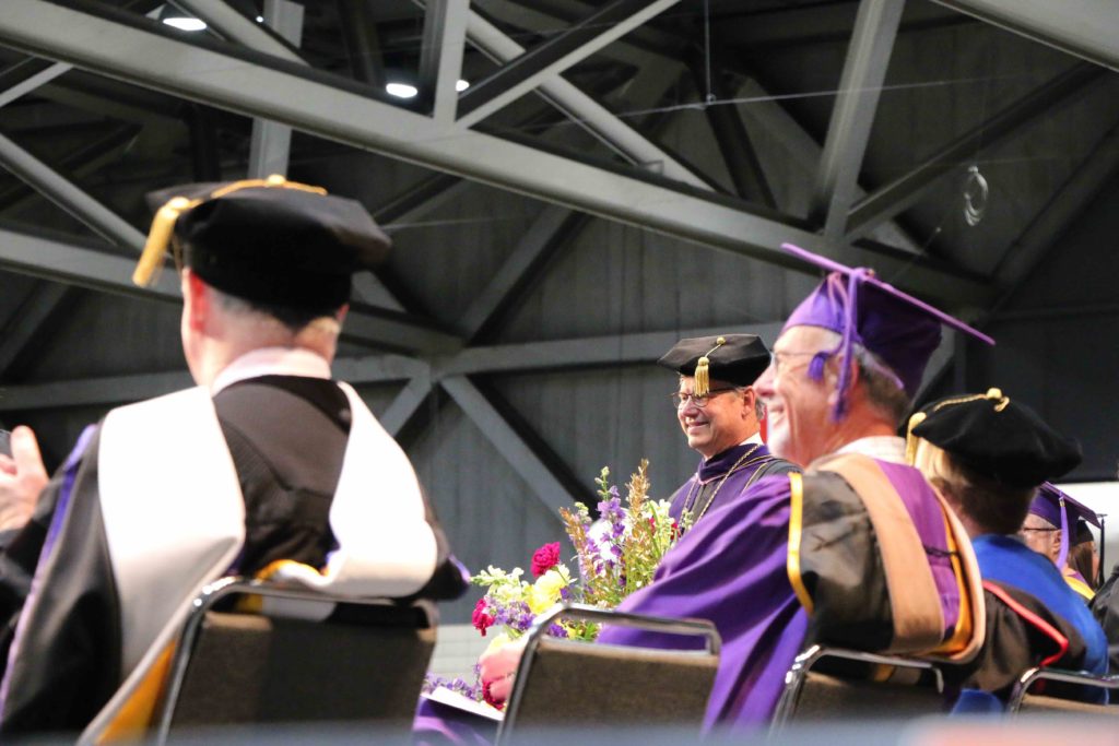 President Ronald Slepitza smiles on the commencement stage
