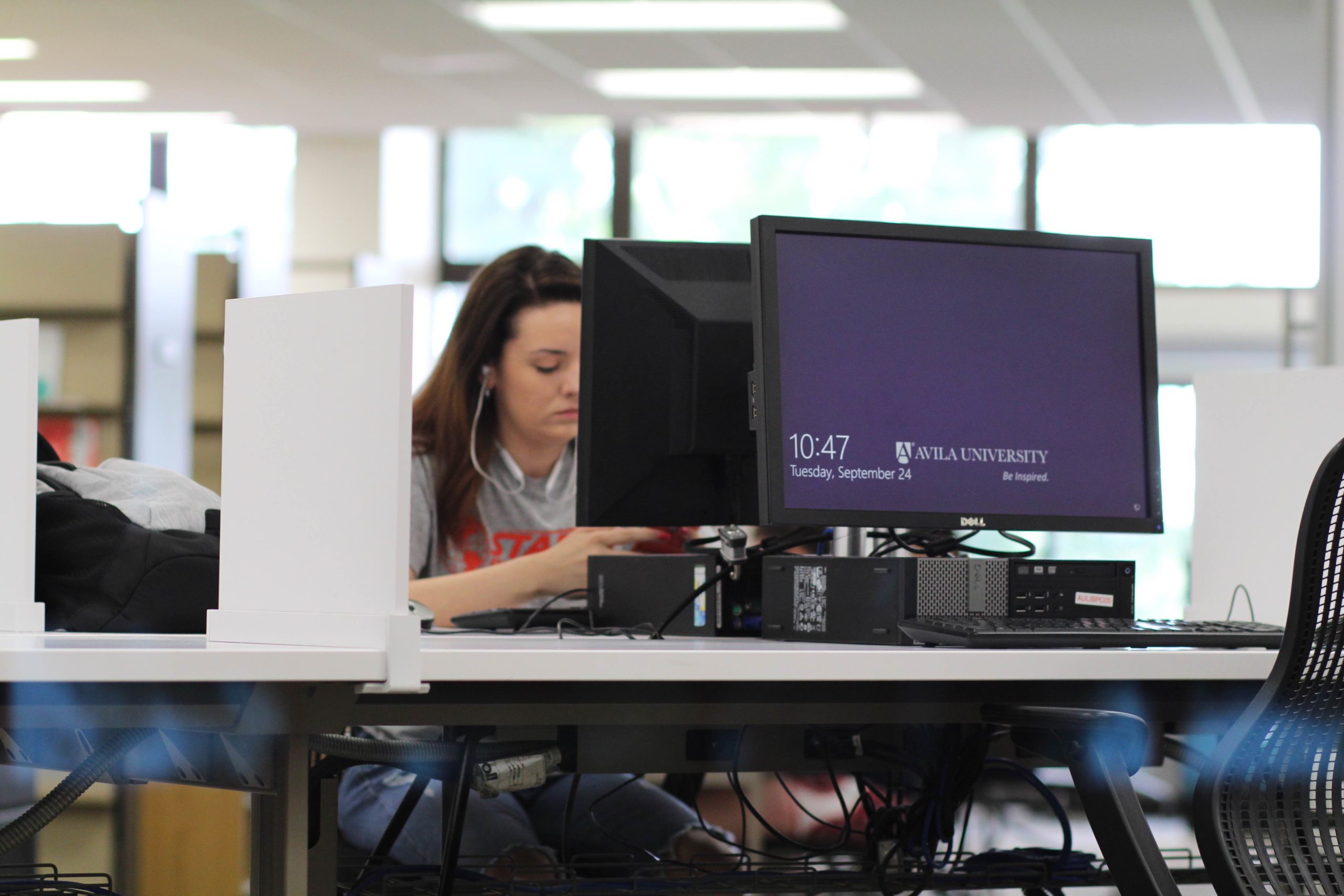 A student works at a computer station in the Learning Commons