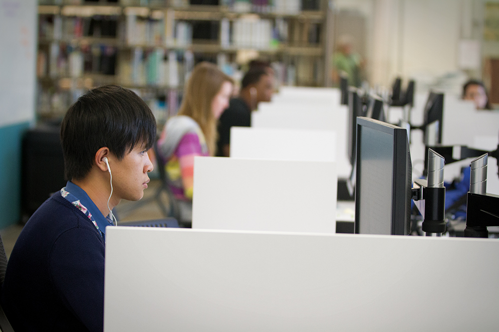 A row of students using the public computers inside the Learning Commons