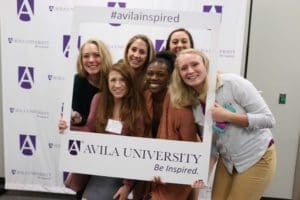 Six student pose in an oversized Polaroid frame. #AvilaInspired and Be Inspired are on the frame