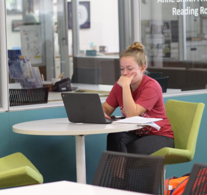 Young woman at desk looking at computer