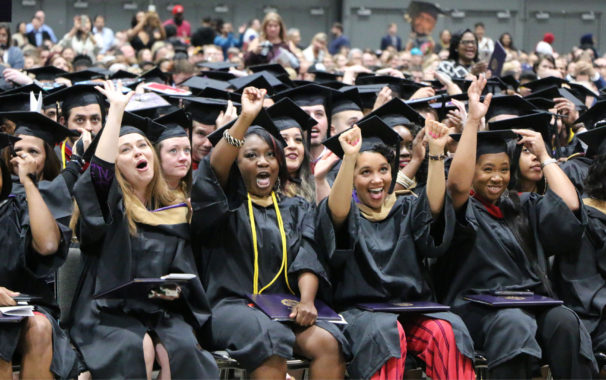 Students cheering during graduation ceremony