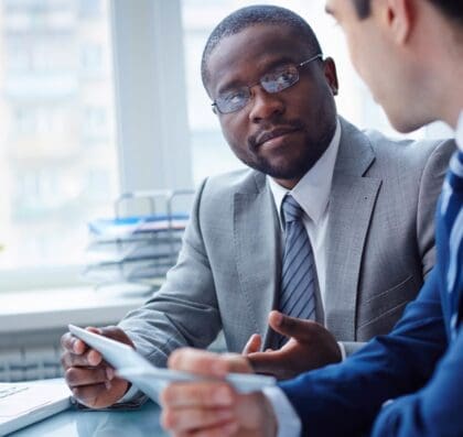 Two business professionals interacting in an office