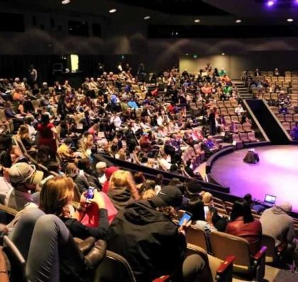 Students seated inside Goppert Theatre for a lecture