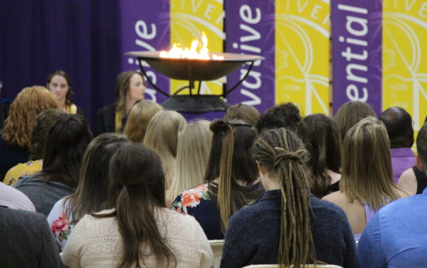 Image of students in audience with Avila flame in the background