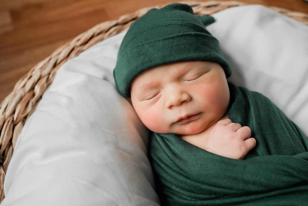 Photo of baby in green clothing