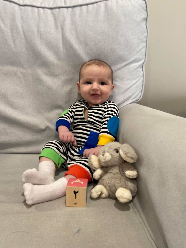 Photo of baby in striped outfit