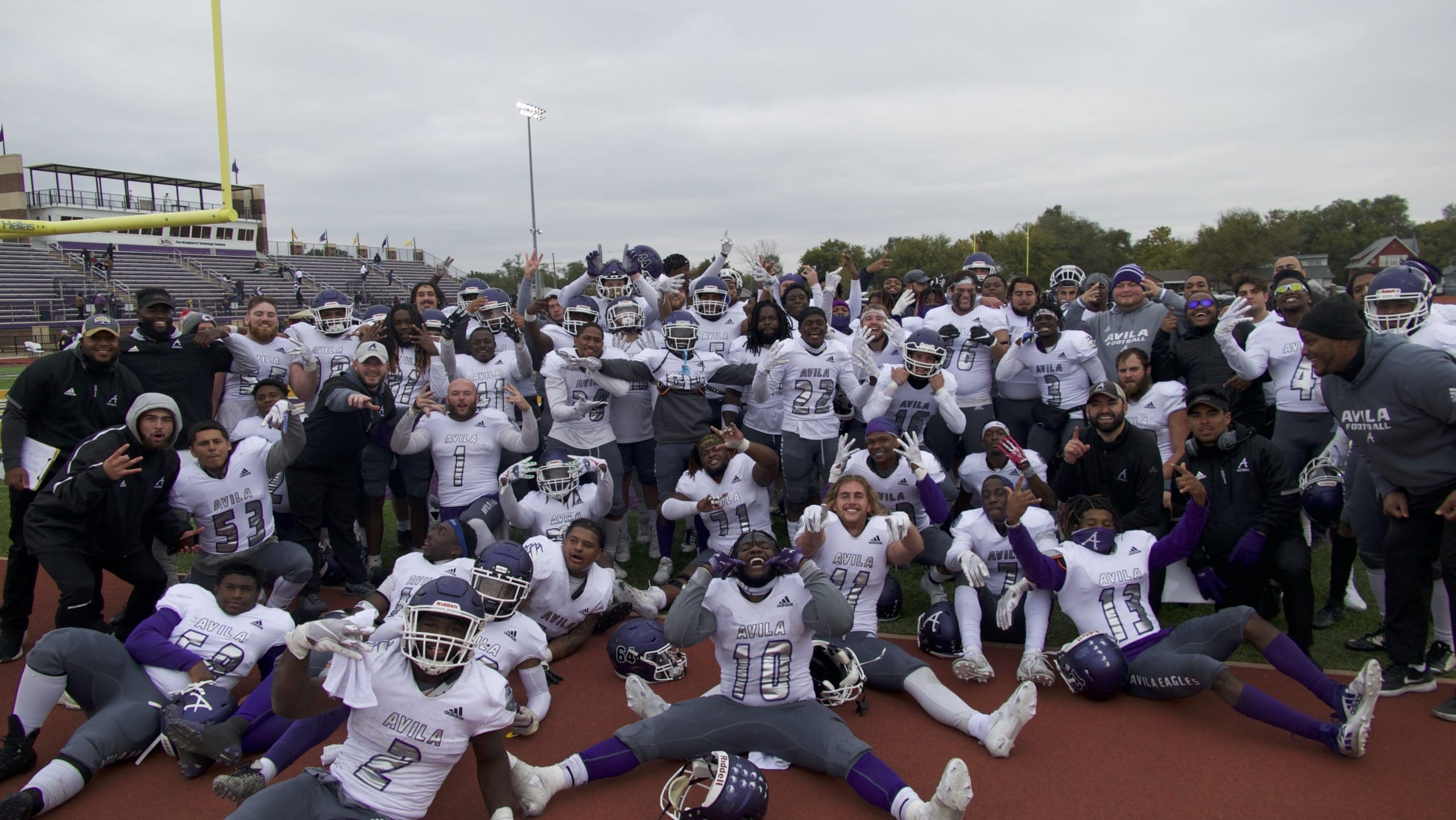 Image of Avila football team celebrating on field after game