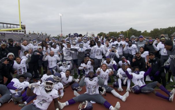 Image of Avila football team celebrating on field after game