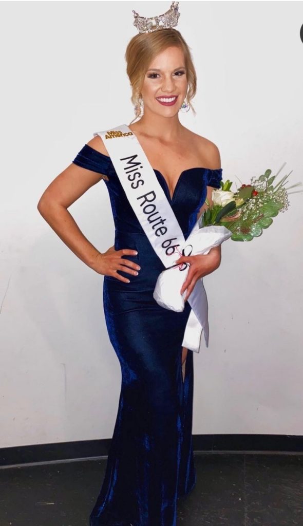 Photo of woman in dress and sash