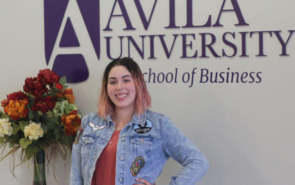 Posed photo of Kristina Noble in front of Avila University School of Business sign
