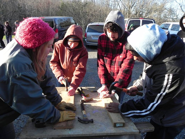 Four students using construction tools