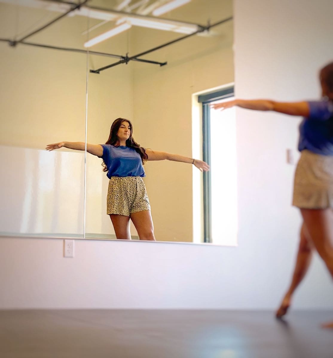 Lone dancer rehearsing in front of mirror