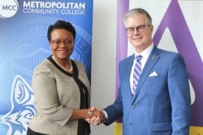 Chancellor Kimberly Beatty (MCC) and President Jim Burkee (Avila) shake hands on a $13.7 million scholarship venture