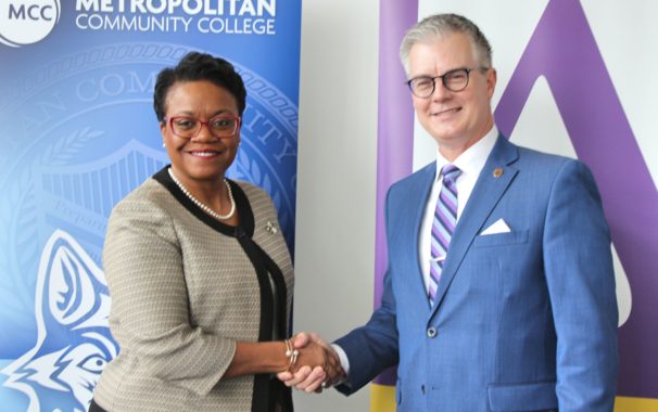 Chancellor Kimberly Beatty (MCC) and President Jim Burkee (Avila) shake hands on a $13.7 million scholarship venture