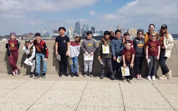Mooneyham with her class on a rooftop with the KC skyline in the background