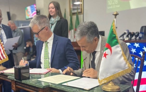 President Burkee signing an agreement with the country of Algeria