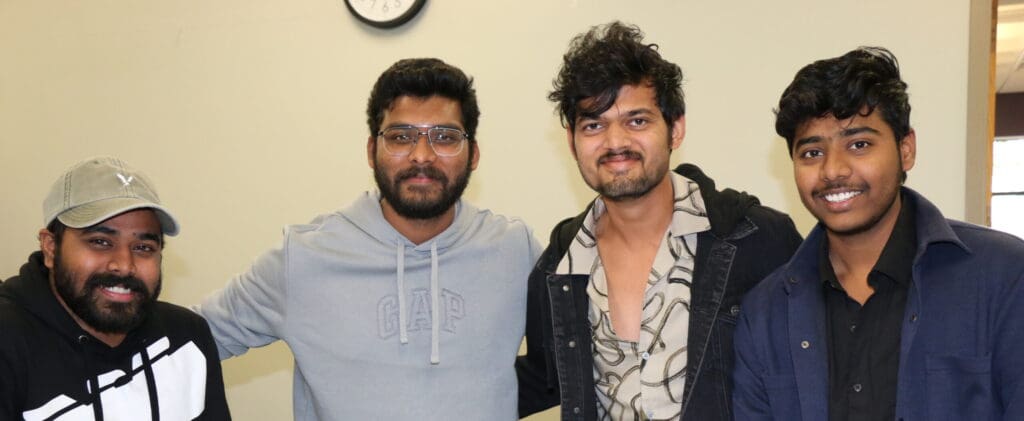 students posing together and smiling for campus photo