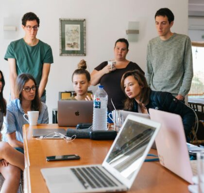 group of people watching on laptop