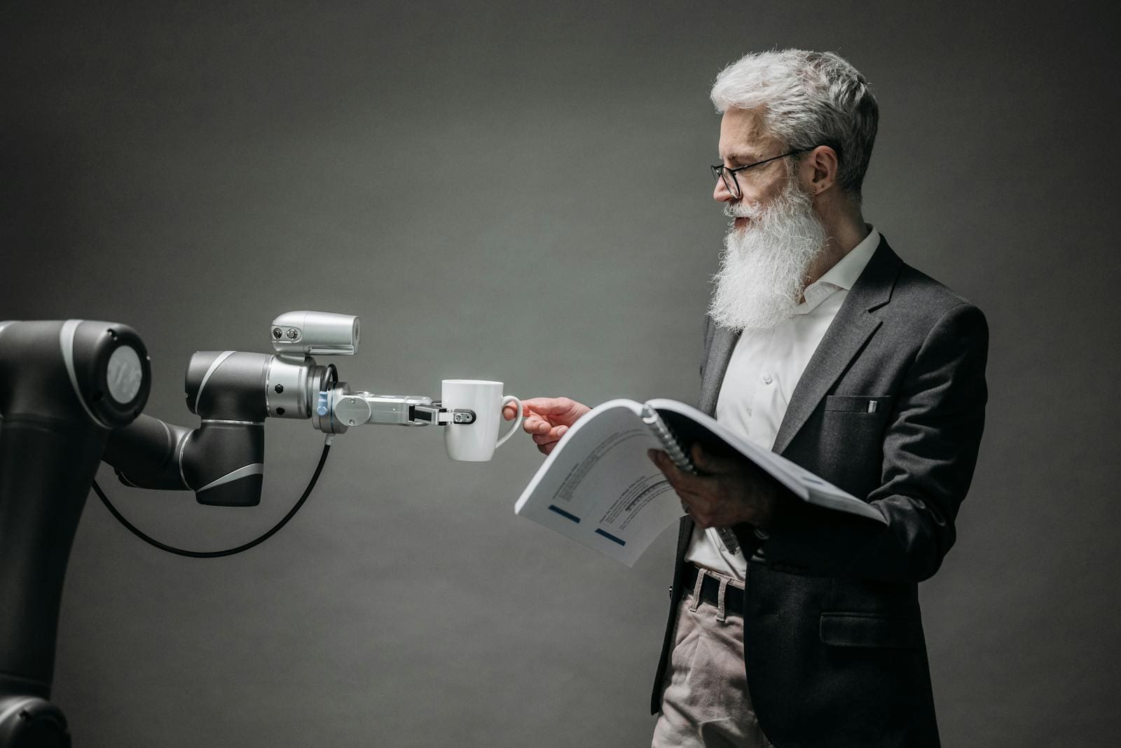 A scientist interacts with a robot helper, demonstrating modern technological innovation.