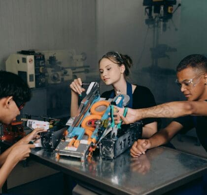 Students engaged in assembling a robotics project in an educational lab setting.